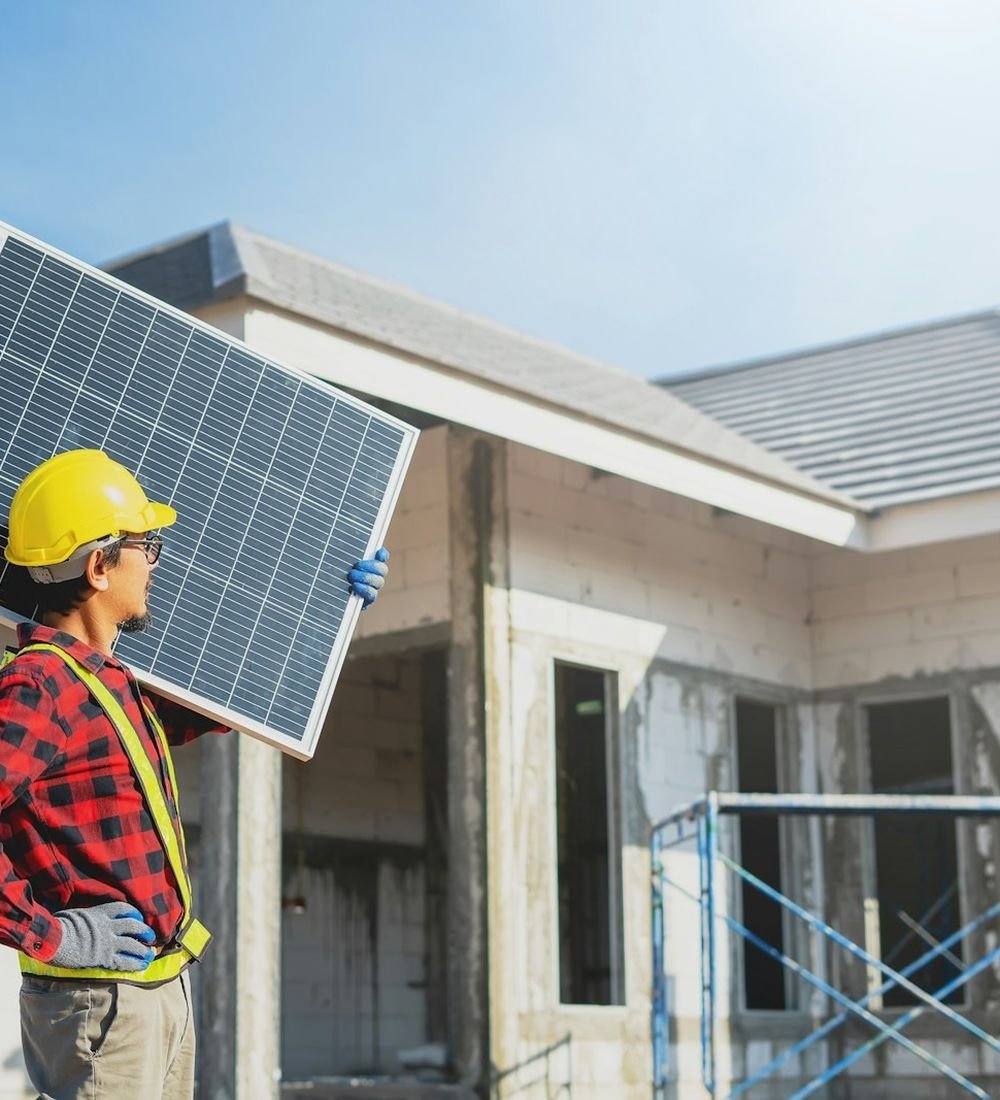 Dynamic Fusion technician carrying a solar panel on site