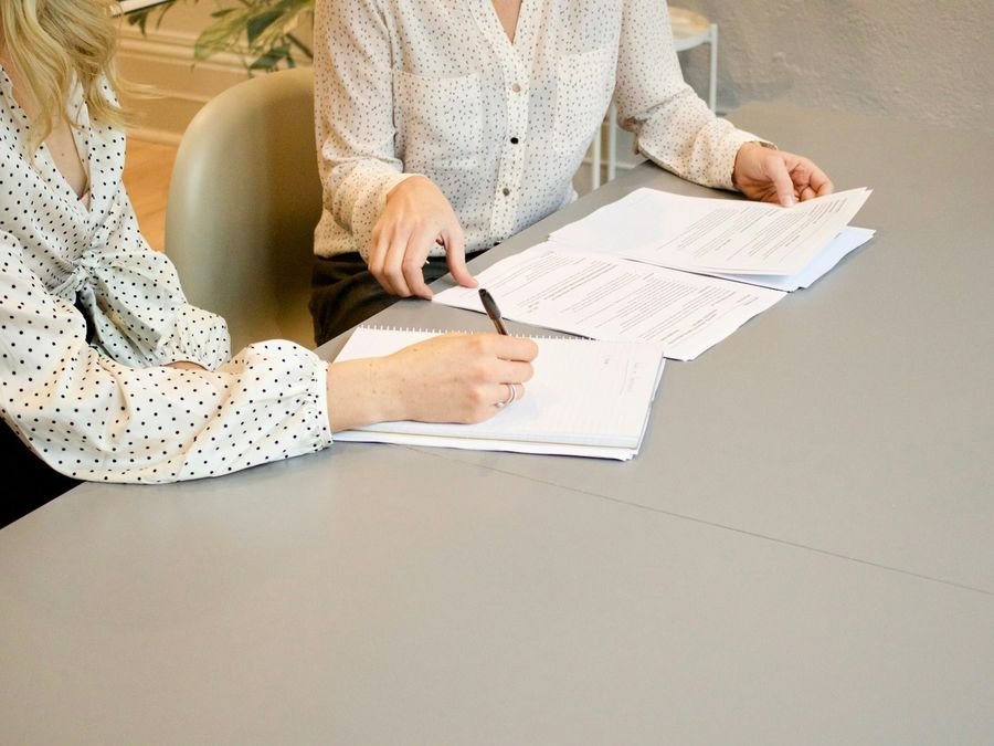 Contract being signed at a desk