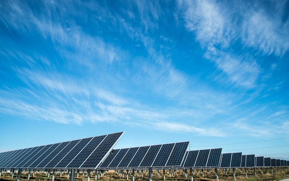 Rows of solar panels on an industrial rooftop